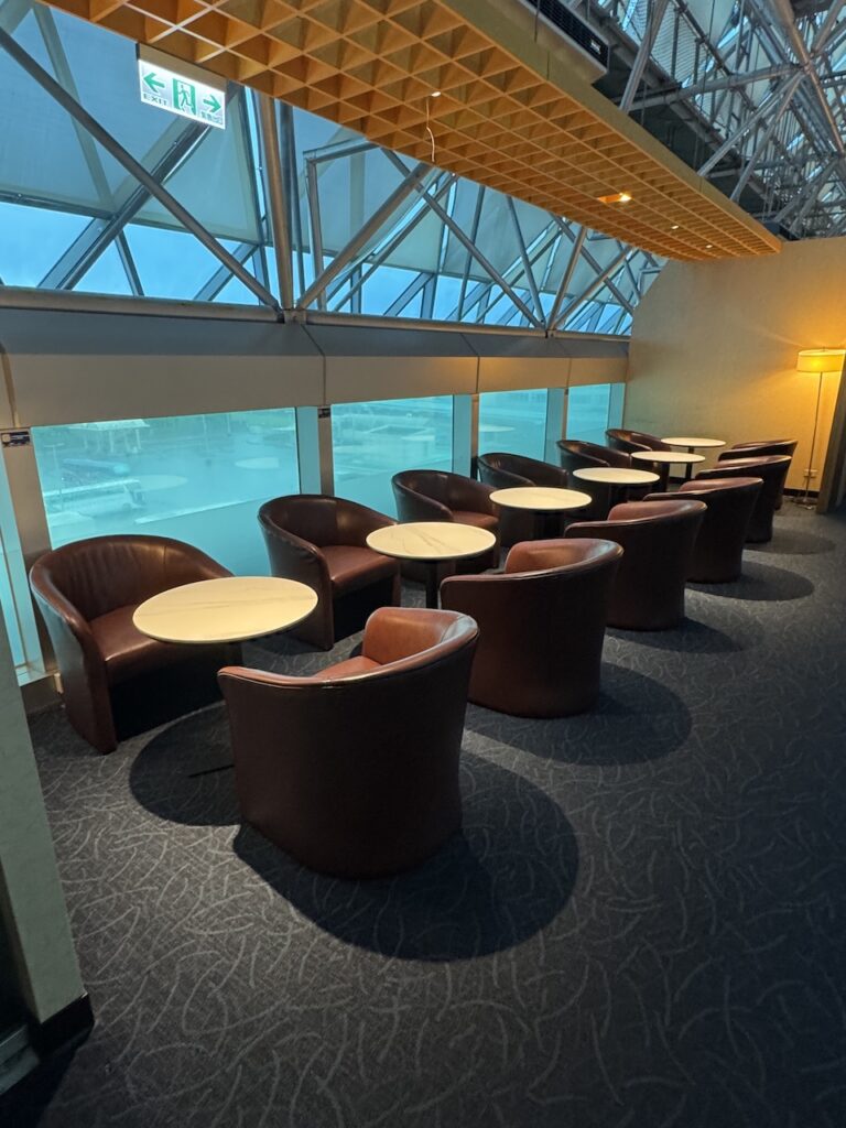 Main lounge floor — paired seating and runway-facing windows