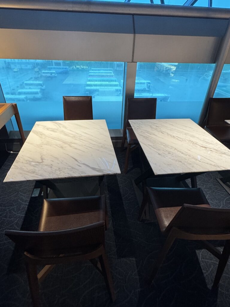 Lounge seating detail — dark wood veneer panels and upholstered seating